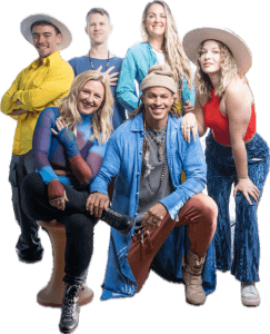 Group of performers posing in colorful outfits