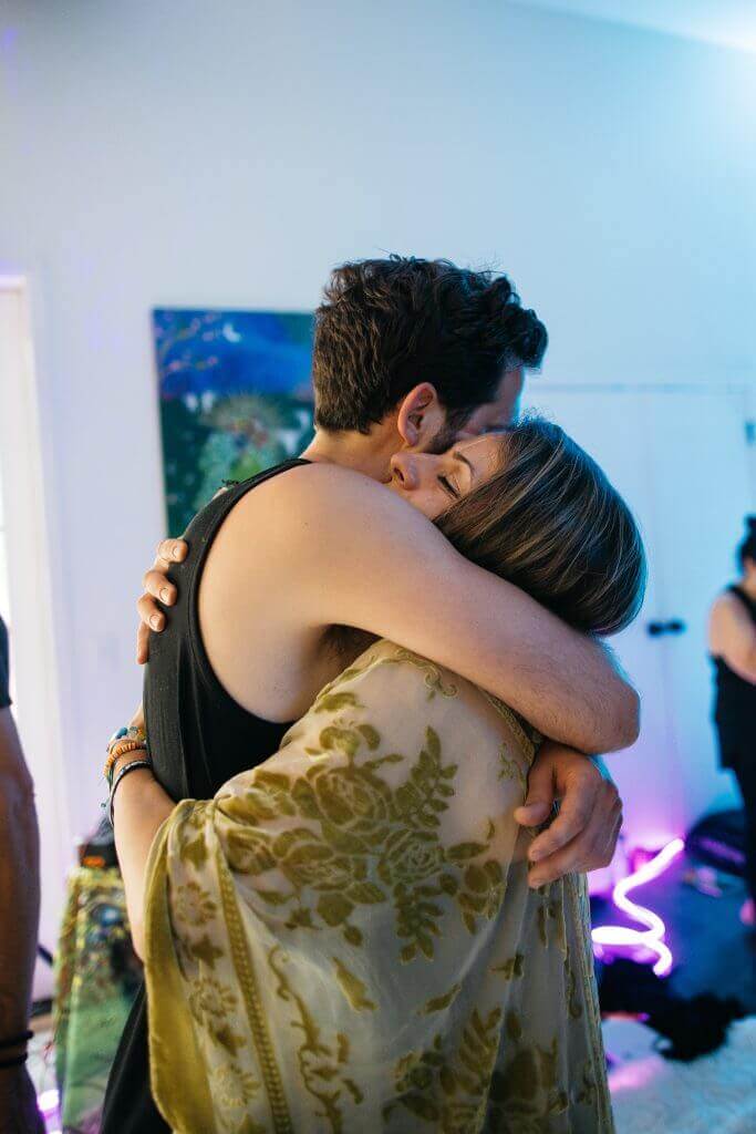 Two participants embracing at Artist Power Awakened