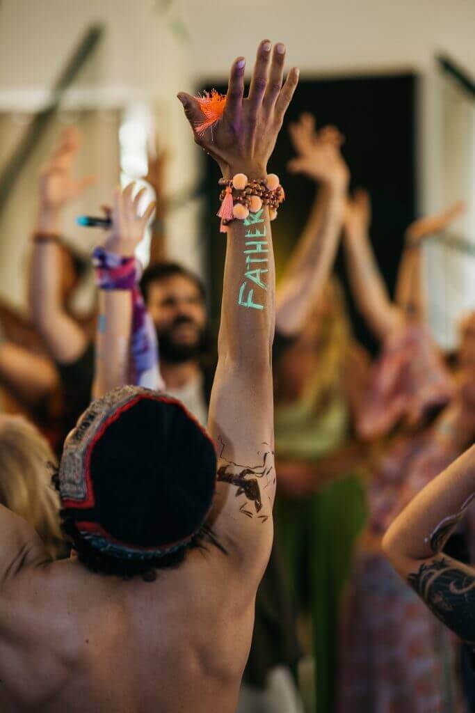 Participants raising hands at Artist Power Awakened