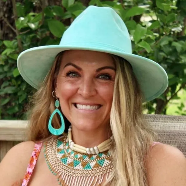Smiling woman in a turquoise hat and jewelry